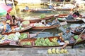 AMPHAWA Ã¢â¬â APRIL 29: Wooden boats are loaded with fruits from the orchards at Tha kha floating market Royalty Free Stock Photo